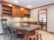 Functional kitchen featuring a breakfast bar, granite countertops, and wood cabinetry at 3815 Glen Haven Sw Dr, Concord, NC 28027