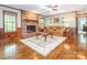 Cozy living room with a brick fireplace, hardwood floors, and a comfortable leather sofa at 3815 Glen Haven Sw Dr, Concord, NC 28027