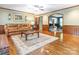 Cozy living room with a brick fireplace, hardwood floors, and access to a formal sitting room at 3815 Glen Haven Sw Dr, Concord, NC 28027
