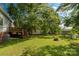 Spacious backyard with mature trees, a deck, shed, and fire pit at 441 Kimbrook Ct, Rock Hill, SC 29730