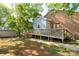Backyard with a brick building and a grey-blue shed-like extension with deck and stairs at 441 Kimbrook Ct, Rock Hill, SC 29730