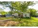 Charming single-story home with well-manicured lawn and mature trees providing ample shade and detached storage at 441 Kimbrook Ct, Rock Hill, SC 29730