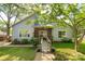 Charming single-story home featuring light blue siding, brick accents, mature landscaping, and a welcoming ramp entrance at 441 Kimbrook Ct, Rock Hill, SC 29730