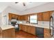 A view of the kitchen with wood cabinets and white countertops at 441 Kimbrook Ct, Rock Hill, SC 29730