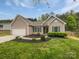 Charming single-story home with a well-manicured front yard and attached two-car garage at 526 Pennyfields Ln, Clover, SC 29710