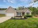 Charming single-story home with a well-manicured front yard and attached two-car garage at 526 Pennyfields Ln, Clover, SC 29710