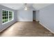 Bright living room featuring vaulted ceiling, large windows, and modern flooring at 526 Pennyfields Ln, Clover, SC 29710