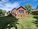Backyard showcases the home's brick exterior and a lovely deck, perfect for outdoor relaxation at 5505 Weavers Row, Gastonia, NC 28056