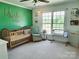 Cozy, carpeted Bedroom with a stylish baby crib and a comfortable rocking chair by the bright window at 5505 Weavers Row, Gastonia, NC 28056
