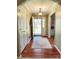 Inviting entryway with hardwood floors, neutral walls, stylish light fixture and seamless transition to the living spaces at 5505 Weavers Row, Gastonia, NC 28056