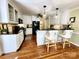 Open kitchen with white cabinets, granite countertops, and a cozy breakfast bar at 5505 Weavers Row, Gastonia, NC 28056