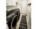 Convenient laundry room with modern Samsung washer and dryer set, cabinetry, and tile flooring at 5505 Weavers Row, Gastonia, NC 28056