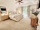 Bright, spacious main bedroom with tray ceiling, an upholstered bed, natural light, and modern decor at 5505 Weavers Row, Gastonia, NC 28056