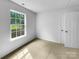 Bright, minimalist bedroom featuring plush carpet and ample closet space at 614 Saratoga Dr, Clover, SC 29710