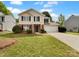 Charming two-story home featuring a classic design, attached two-car garage, manicured front lawn, and traditional architectural details at 614 Saratoga Dr, Clover, SC 29710
