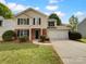 Charming two-story home featuring a classic design, attached two-car garage, manicured front lawn, and traditional architectural details at 614 Saratoga Dr, Clover, SC 29710