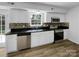 Modern kitchen with stainless steel appliances, dark countertop, and bright white cabinets at 614 Saratoga Dr, Clover, SC 29710