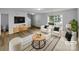 Bright living room boasts a modern design, light-colored flooring, two white armchairs, and a view of the outside scenery at 614 Saratoga Dr, Clover, SC 29710