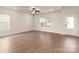 Bright and airy living room featuring luxury vinyl flooring, ceiling fan, and natural light at 7011 Jerimoth Dr, Charlotte, NC 28215