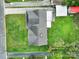 Overhead view of a house featuring a dark roof, small patio, and lush backyard at 7410 Middlebury Pl, Charlotte, NC 28212