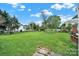 Large backyard with grass, landscaping, and a fence at 7410 Middlebury Pl, Charlotte, NC 28212