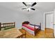 Inviting bedroom featuring hardwood floors, a ceiling fan, and neutral paint at 7410 Middlebury Pl, Charlotte, NC 28212