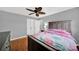 Bedroom with hardwood floors, ceiling fan, neutral walls and double door closet at 7410 Middlebury Pl, Charlotte, NC 28212