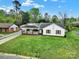 Attractive single-story home with a covered porch, red shutters, and well-kept lawn at 7410 Middlebury Pl, Charlotte, NC 28212