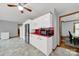 Bright open kitchen leads to a large dining area, featuring white cabinets and stainless appliances at 7410 Middlebury Pl, Charlotte, NC 28212