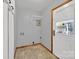 Clean laundry room with tile flooring, door to back yard, and crisp paint at 7410 Middlebury Pl, Charlotte, NC 28212