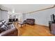 Open-concept living area with hardwood floors and seamlessly adjoined dining space at 7410 Middlebury Pl, Charlotte, NC 28212