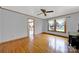 Hardwood living room with a large window and view, and a doorway into the kitchen at 7410 Middlebury Pl, Charlotte, NC 28212