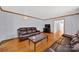 Comfortable living room features gleaming hardwood floors and classic trim at 7410 Middlebury Pl, Charlotte, NC 28212