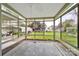 Bright sunroom with tiled floor and expansive windows overlooking the backyard at 7410 Middlebury Pl, Charlotte, NC 28212