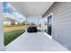 Covered back patio with a concrete pad, and a closed sliding glass door at 8143 Warford Little Rd, Denver, NC 28037
