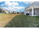 Back yard featuring grass and a view of the covered back patio, along with neighboring houses at 8143 Warford Little Rd, Denver, NC 28037