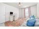 Bright bedroom with a desk, comfortable sofa, and stylish decor for a cozy workspace at 8143 Warford Little Rd, Denver, NC 28037