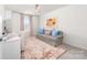 Sunlit bedroom features a desk area, cozy sofa, and charming decorative accents at 8143 Warford Little Rd, Denver, NC 28037