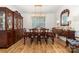 Elegant dining room with hardwood floors, a grand hutch, chandelier, and stylish furnishings at 8143 Warford Little Rd, Denver, NC 28037