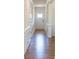Bright hallway with hardwood floors, white trim, and paneled doors leading to various rooms at 8143 Warford Little Rd, Denver, NC 28037