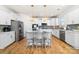 Modern kitchen featuring white cabinets, stainless steel appliances, a center island, and stylish pendant lighting at 8143 Warford Little Rd, Denver, NC 28037