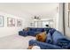Inviting living room with a comfortable blue sectional, large windows, and neutral decor at 8143 Warford Little Rd, Denver, NC 28037