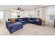 Spacious living room featuring a plush blue sectional sofa and bright natural light at 8143 Warford Little Rd, Denver, NC 28037