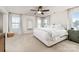 Bright main bedroom featuring plush carpeting, a ceiling fan, and large windows providing natural light at 8143 Warford Little Rd, Denver, NC 28037