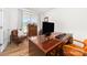 Well-lit home office with a large wooden desk, leather chairs, and ample space for work or study at 8143 Warford Little Rd, Denver, NC 28037