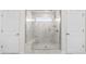 Large shower with glass door and marble tile with seating, and a window for natural light at 8143 Warford Little Rd, Denver, NC 28037