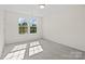 Sunlit bedroom with neutral carpet and walls, featuring two large windows at 9618 Springholm Dr, Charlotte, NC 28278