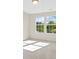 Bright bedroom with neutral carpet and walls, featuring two large windows overlooking the outdoors at 9618 Springholm Dr, Charlotte, NC 28278