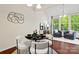 Elegant dining area with stylish furniture, modern decor, and natural light from large windows at 9618 Springholm Dr, Charlotte, NC 28278
