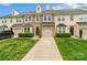 Charming townhouse showcasing a stone facade, two-car garage, and well-manicured lawn at 9618 Springholm Dr, Charlotte, NC 28278